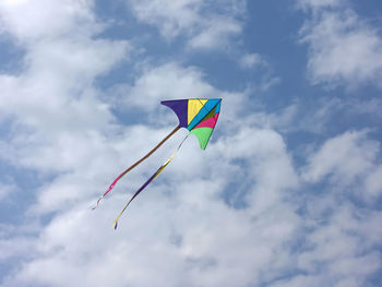 Low angle view of kite flying against sky