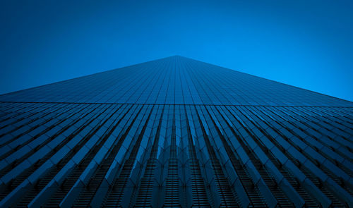 Low angle view of modern building against clear blue sky