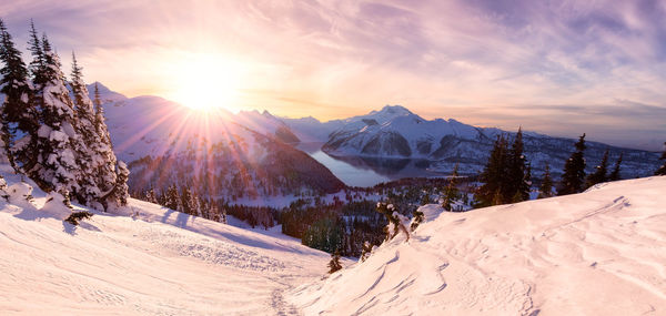 Scenic view of snowcapped mountains against sky during sunset