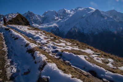 Scenic view of snow covered mountains against clear sky