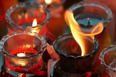 Close-up of lit tea light candles in temple