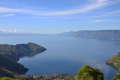 Scenic view of sea and mountains against sky