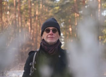 Portrait of man wearing sunglasses in forest