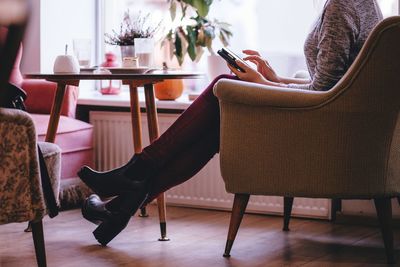 Woman sitting on chair at home