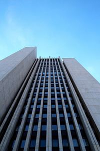 Low angle view of modern building against clear blue sky