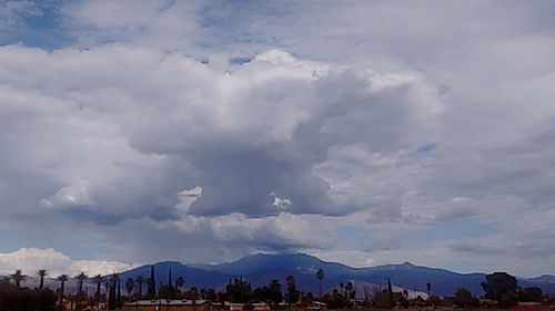 Scenic view of mountains against cloudy sky