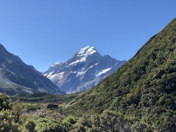 Scenic view of mountains against clear blue sky