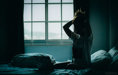 Woman relaxing on bed at home