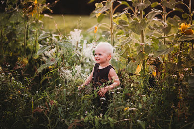 Smiling toddler in the middle of a flower field