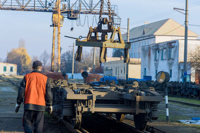 Rear view of people working at construction site