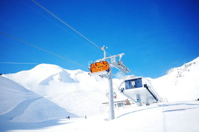 Overhead cable car against snowcapped mountains during winter