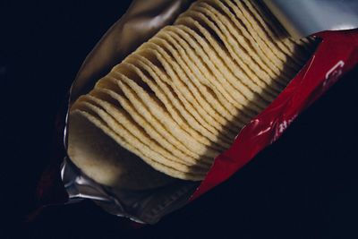 Close-up of potato chips against black background