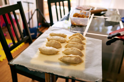 Cropped hand of person preparing food on table