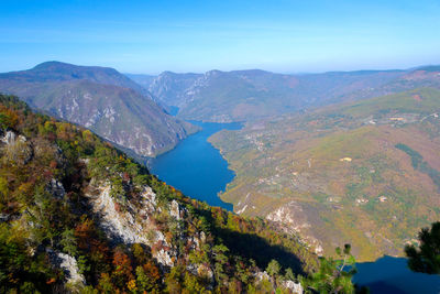 Scenic view of mountain range against blue sky