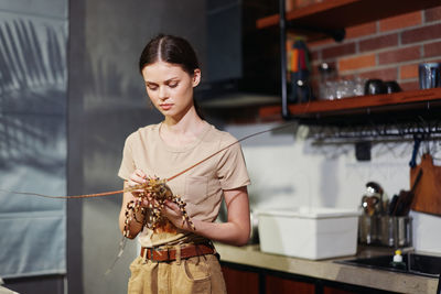Side view of young woman holding bouquet