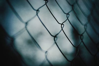 Close-up of chainlink fence against sky