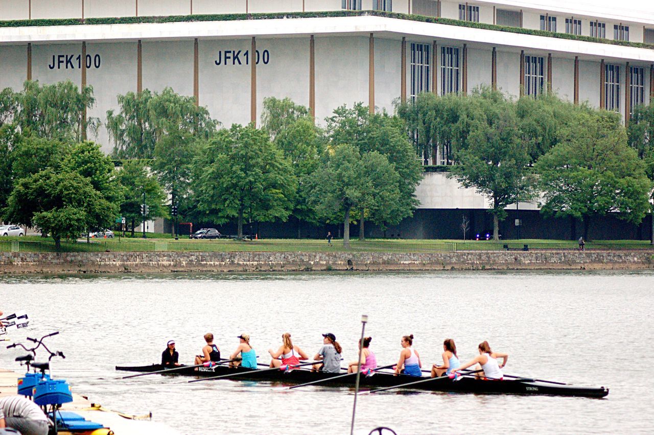 PEOPLE SITTING AT RIVERBANK