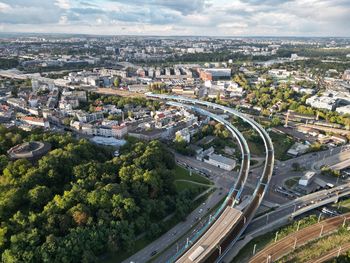 High angle view of cityscape with train tracks and roads