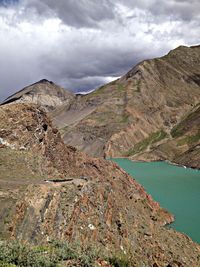 Scenic view of mountains against cloudy sky