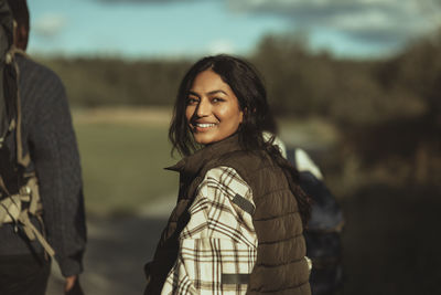 Portrait of smiling woman standing outdoors