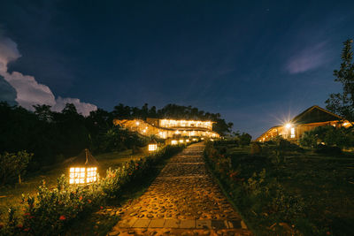 Illuminated buildings against sky at night