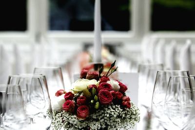 Close-up of bouquets and wineglasses on table