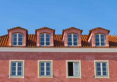 Low angle view of building against clear blue sky