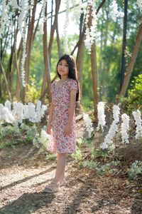 Full length of girl standing in forest