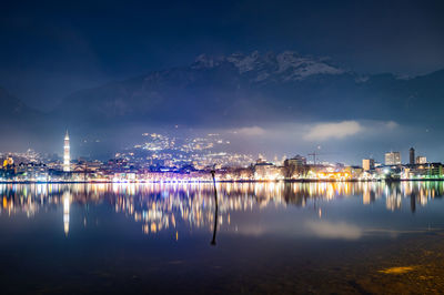 The city of lecco, with lakeside promenade and its buildings, photographed in the evening in winter.