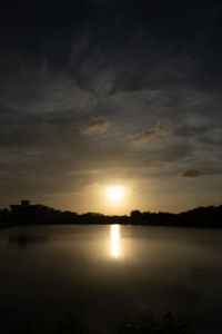 Scenic view of lake against sky during sunset