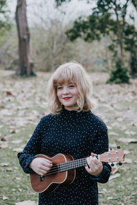 Full length of a girl playing guitar