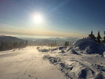 Scenic view of snow covered landscape against sky