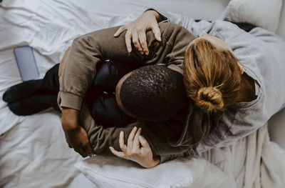 High angle view of woman sleeping on bed at home