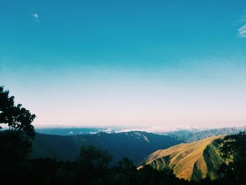 Scenic view of mountains against clear blue sky