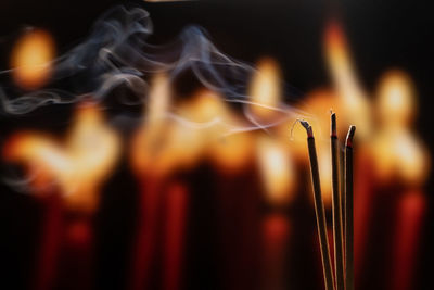 Close-up of lit candles in temple