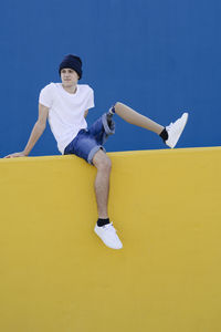 Handicapped teenager sitting on fence