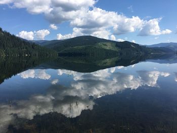 Scenic view of lake and mountains against sky