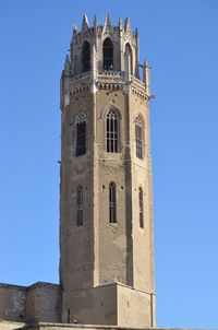 Low angle view of historical building against clear blue sky