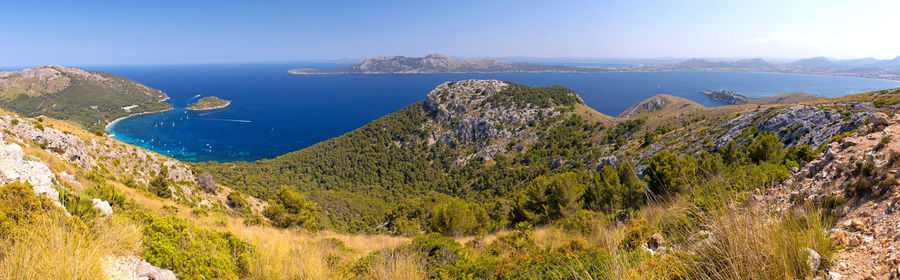 Panoramic view of sea and mountains against sky