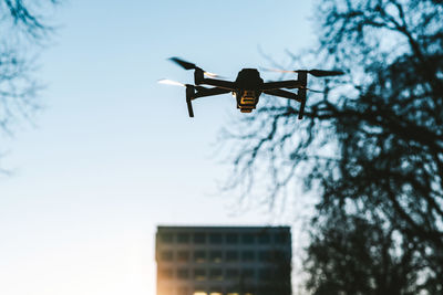 Low angle view of drone against clear sky