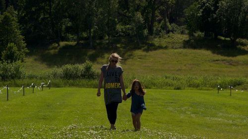 Full length of man standing on grassy field