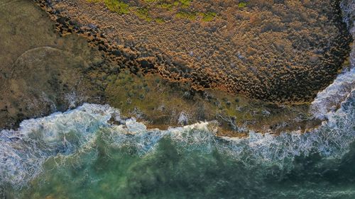 High angle view of rocks in sea