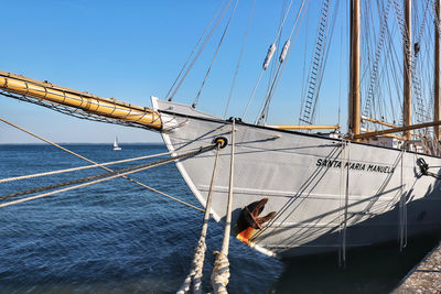 Sailboat sailing on sea against clear sky