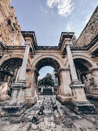 Low angle view of old ruins against sky