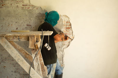 Woman standing against wall