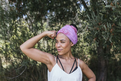 Portrait of woman standing against plants