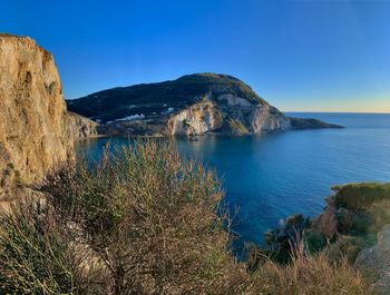 Scenic view of sea against clear blue sky