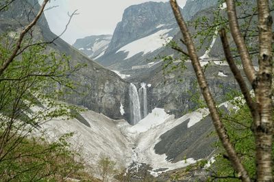 High angle view of waterfall amidst mountains