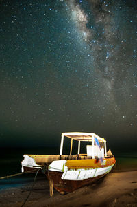 Boat on lake against sky at night