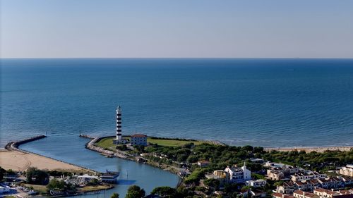 Scenic view of sea against clear sky with light house